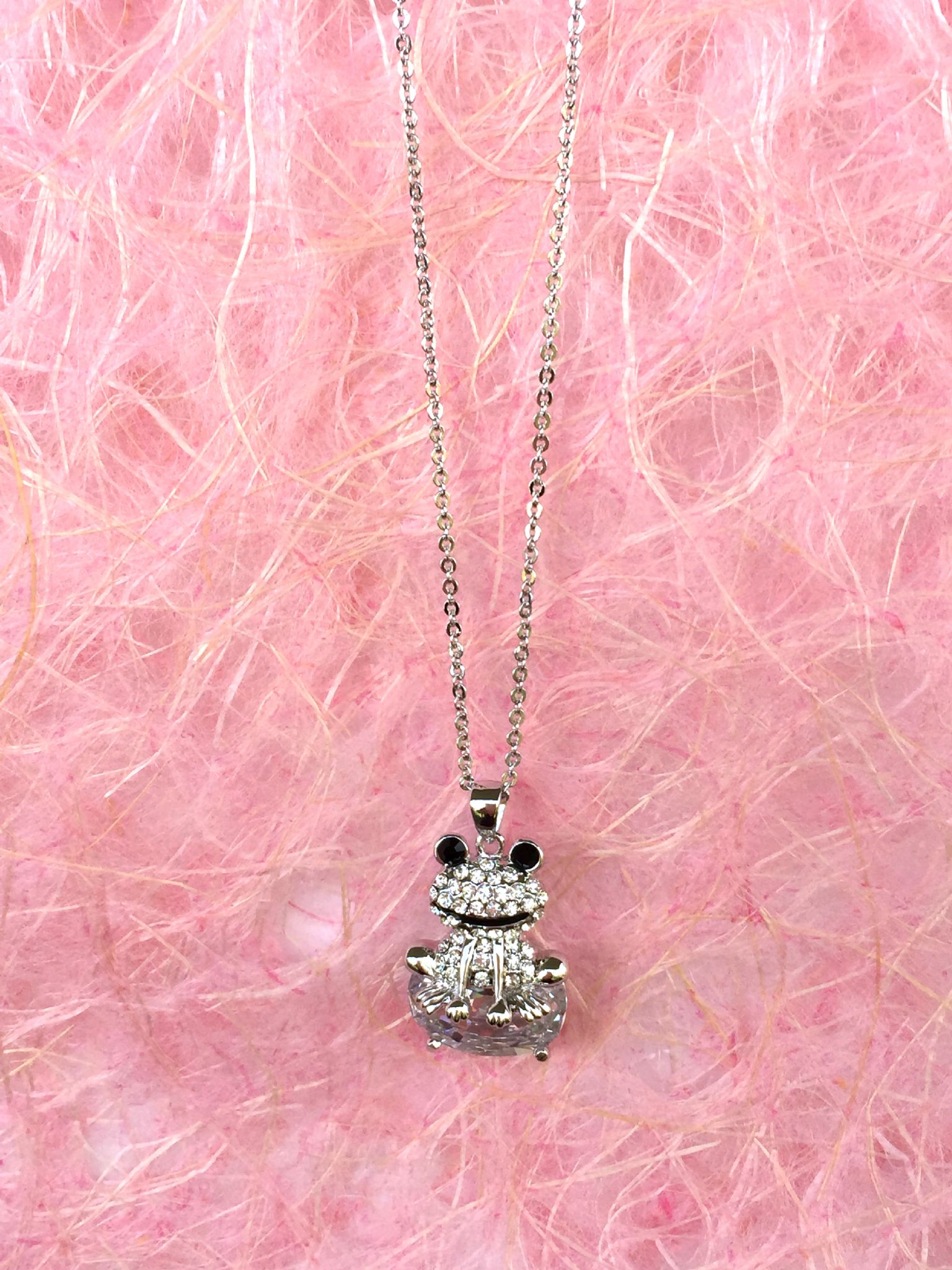 A beautiful butterfly pendant made of mother of pearl and emblazoned with small glittering crystals on a gold metal base. J020010