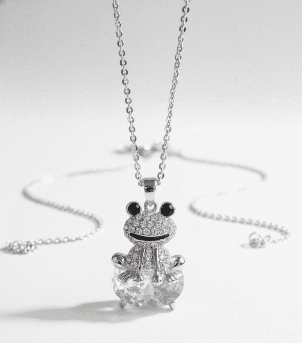 A beautiful butterfly pendant made of mother of pearl and emblazoned with small glittering crystals on a gold metal base. J020010