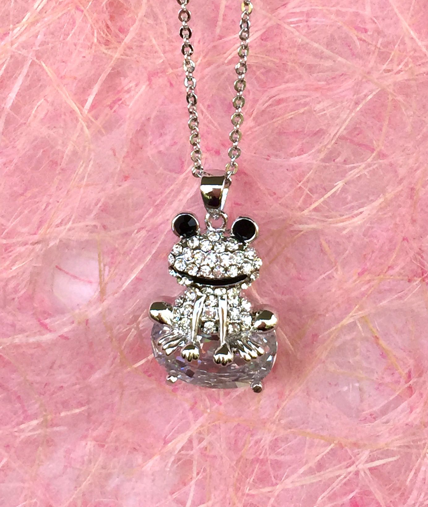 A beautiful butterfly pendant made of mother of pearl and emblazoned with small glittering crystals on a gold metal base. J020010