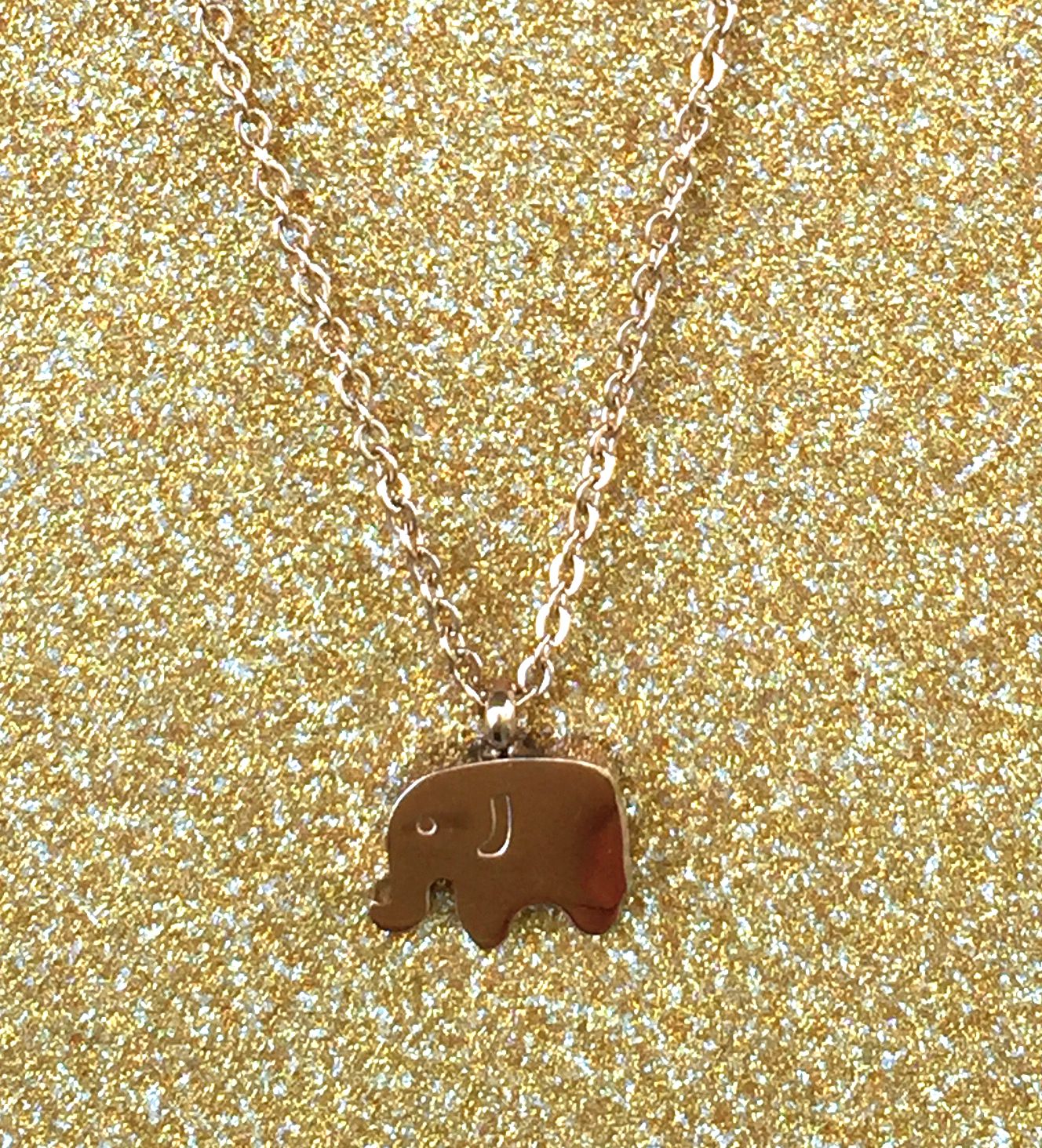 A beautiful butterfly pendant made of mother of pearl and emblazoned with small glittering crystals on a gold metal base. J020010