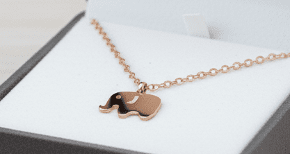 A beautiful butterfly pendant made of mother of pearl and emblazoned with small glittering crystals on a gold metal base. J020010