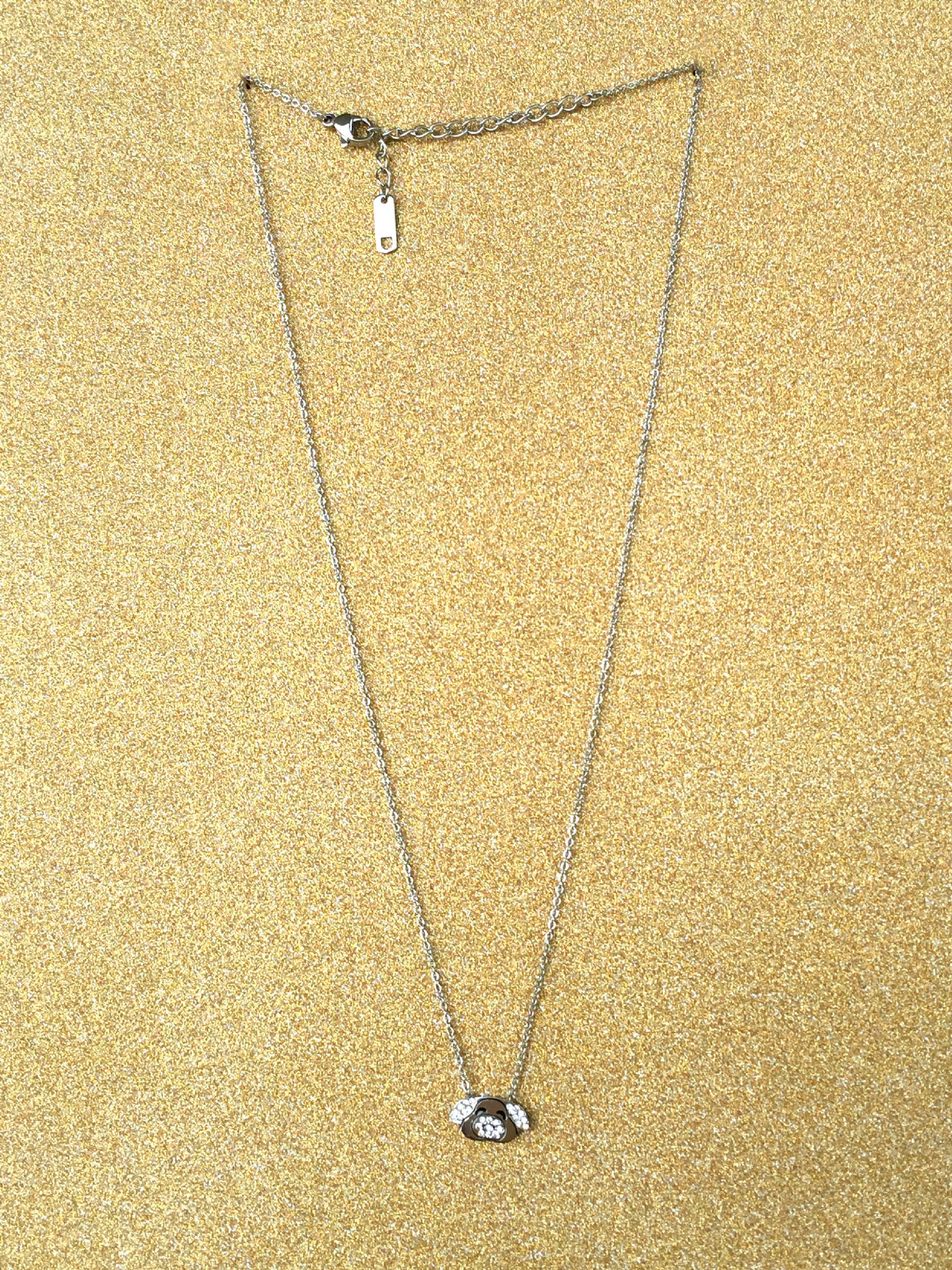 A beautiful butterfly pendant made of mother of pearl and emblazoned with small glittering crystals on a gold metal base. J020010