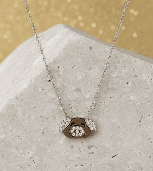 A beautiful butterfly pendant made of mother of pearl and emblazoned with small glittering crystals on a gold metal base. J020010