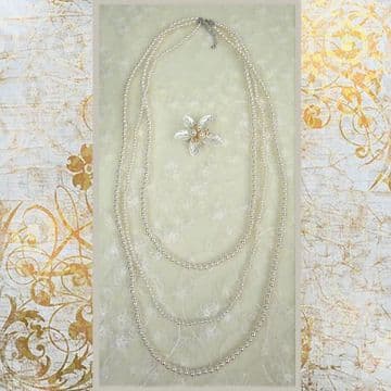 J010075 Three strings of pearls with removable triple bow pearl brouche