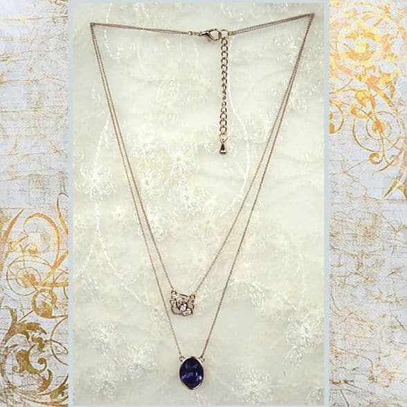 PA10160 rose gold chain with a shimmering embroidery rose and a blue crystal pendant