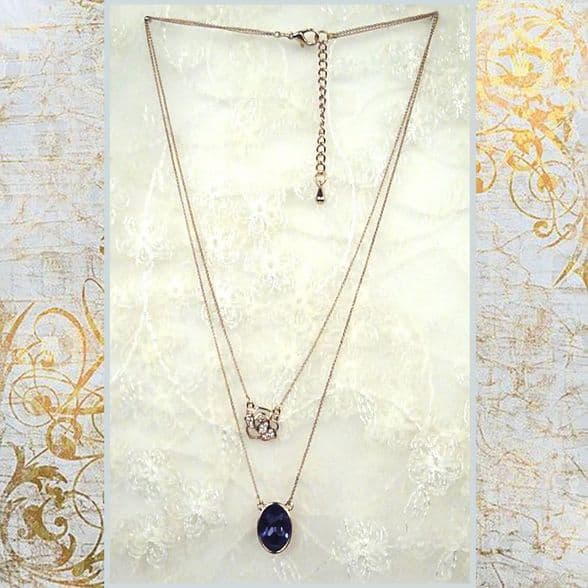 PA10160 rose gold chain with a shimmering embroidery rose and a blue crystal pendant