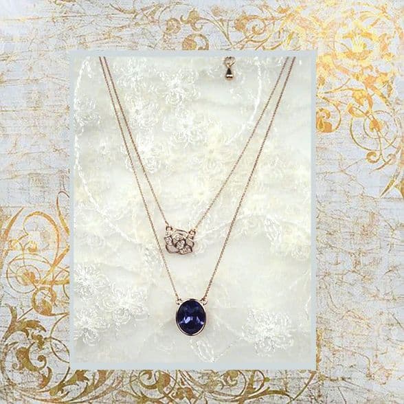 PA10160 rose gold chain with a shimmering embroidery rose and a blue crystal pendant