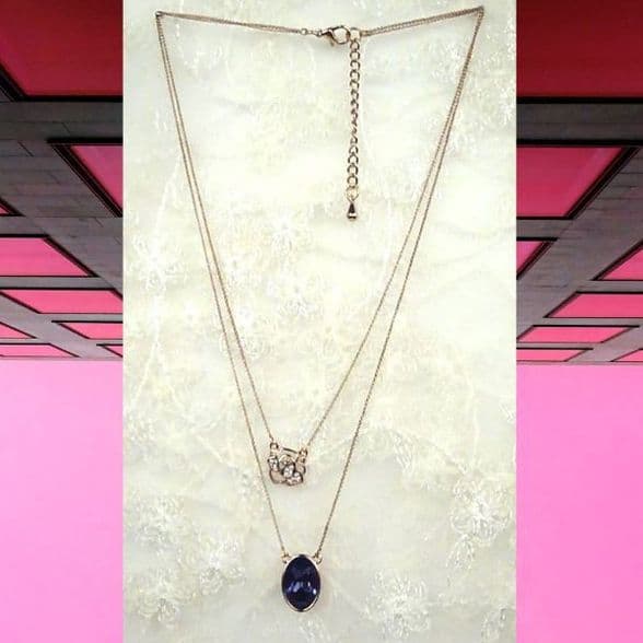 PA10160 rose gold chain with a shimmering embroidery rose and a blue crystal pendant