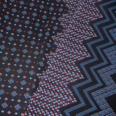Polyester Bubble Crepe Dress Fabric -  Red, Blue Pattern on Black. Zig Zag On Sides.