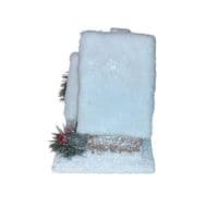 Christmas Forest illuminated Chalet House with a Snow Covered Roof