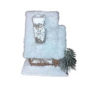 Christmas Forest illuminated Chalet House with a Snow Covered Roof