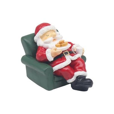 Santa relaxing in a chair with mince pies