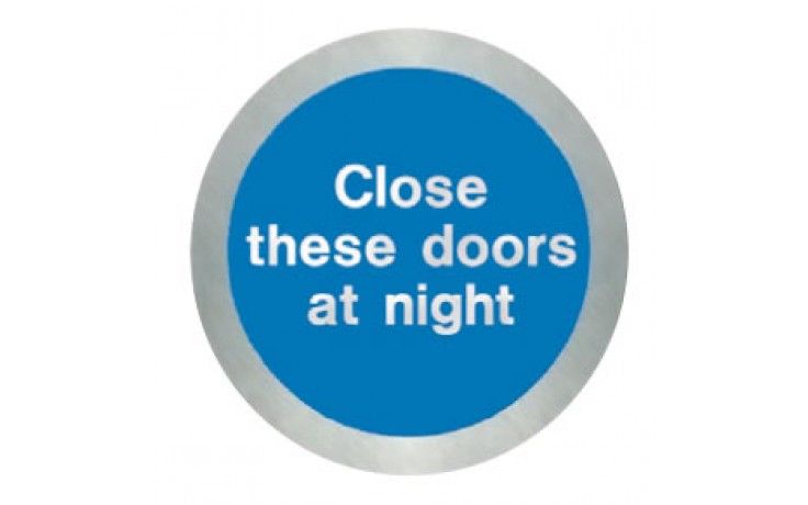SS5124O - STAINLESS STEEL CLOSE THESE DOORS AT NIGHT DISC. Fire door sign