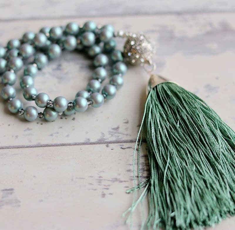 Long tassel necklace with pale green pearls