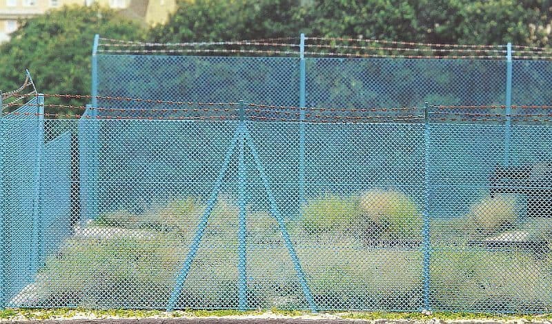 Premium AI Image | Barbed Wire Fence Around Military Base Or Prison