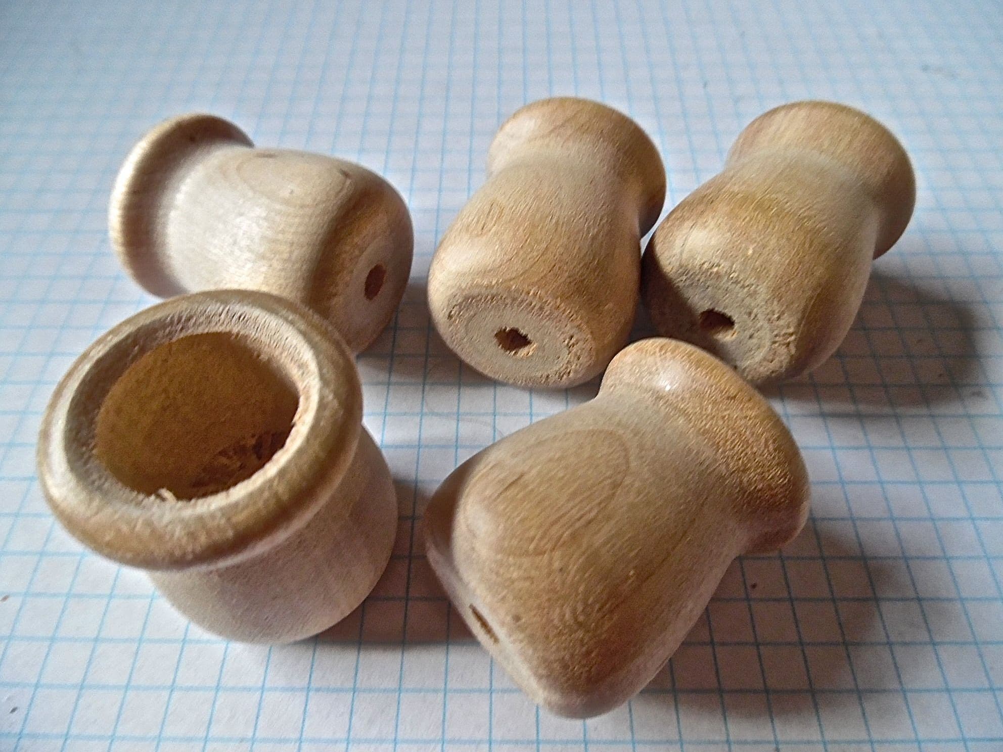 Wooden peg dolls in top cups