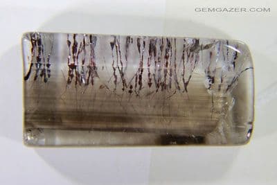 Colourless & Smoky Quartz cabochon with Hematite (Lepidocrocite) inclusions, Brazil.  20.65 carats.