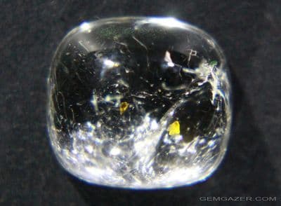 Colourless Topaz cabochon with Microlite inclusions, Pakistan.  5.22 carats.