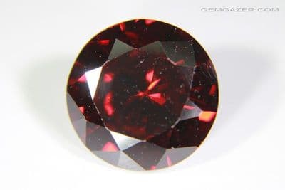 Cubic Zirconia (CZ), dark red faceted. 6.07 carats.
