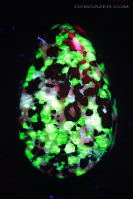 Fluorescent Calcite, Zincite, Franklinite & Willemite cabochon, USA. 133.15 carats.