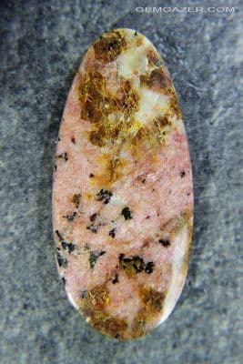 Fluorescent Rhodonite cabochon, 57.89 carats, USA.