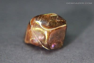 Iridescent Andradite Garnet tumbled crystal, Japan. 9.48 carats.