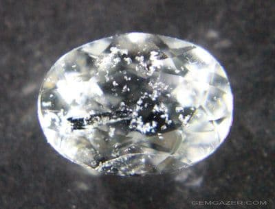 Pale blue Topaz with Columbite and Fluorite inclusions, faceted, Brazil.  3.76 carats.