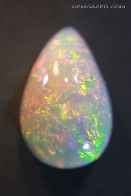 Precious Opal cabochon, dark base, Ethiopia. 12.66 carats. (Video)