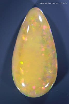 Precious Opal cabochon, yellow-orange, Welo, Ethiopia, 42.77 carats. (Video)