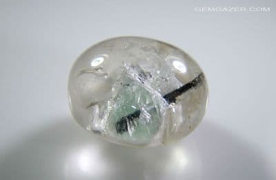 Quartz cabochon with blue Calcite & Tourmaline inclusions, Brazil. 9.32 carats.