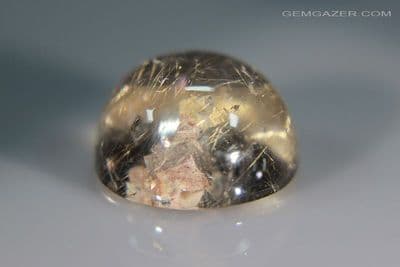 Quartz cabochon with Calcite and Rutile inclusions, Brazil. 14.42 carats.