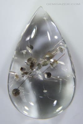 Quartz cabochon with Calcite and Rutile needle incusions, Brazil. 42.16 carats.