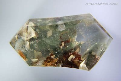 Quartz cabochon with Calcite crystals and Lodolite, China. 187.88 carats. (Video)