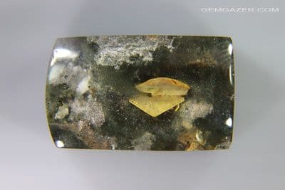 Quartz cabochon with Calcite crystals and Lodolite, China. 28.56 carats. (Video)