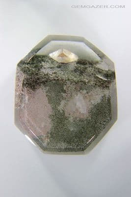 Quartz cabochon with Calcite crystals and Lodolite, China. 33.04 carats.