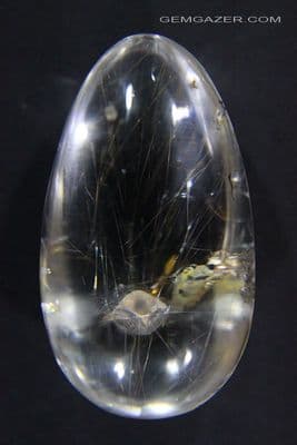 Quartz cabochon with Calcite & Rutile inclusions, China. 65.15 carats.