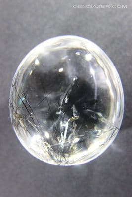 Quartz cabochon with Fuchsite mica & Tourmaline, China.  119.08 carats.