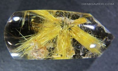 Quartz cabochon with golden Rutile inclusion spray, Brazil.  55.83 carats.