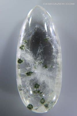 Quartz cabochon with radial green Actinolite inclusions, China. 39.66 carats.