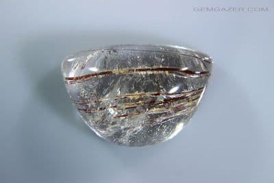 Quartz cabochon with red Rutile needle inclusions, Brazil. 16.42 carats.