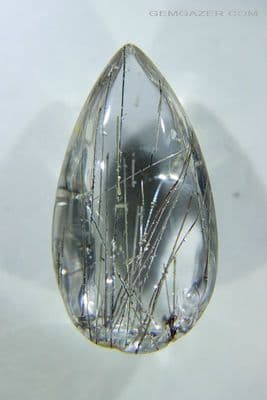 Quartz cabochon with Rutile & negative crystal inclusions, Brazil. 27.63 carats.