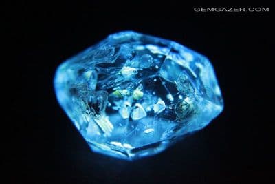 Quartz crystal with fluorescent Petroleum inclusions, Pakistan. 12.24 carats.