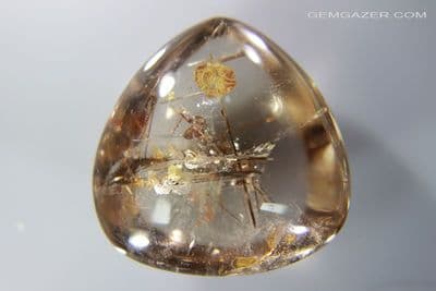 Smoky Quartz cabochon with Calcite & Rutile inclusions, China. 81.40 carats.