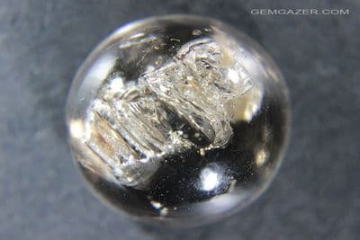 Smoky Quartz cabochon with negative crystal inclusions, Brazil.  36.16 carats.
