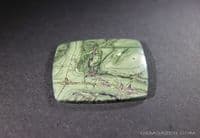 Tinguaite, green cabochon.  37.11 carats.