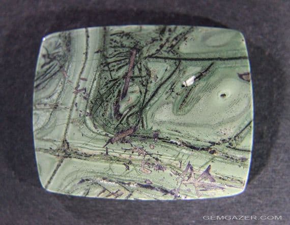 Tinguaite, green cabochon.  37.11 carats.