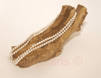 A 36 inch long string of small and perfect AA grade white pearls