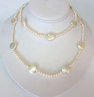 Large coin-shaped pearls on a 36 inch string of small round pearls.