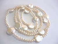 Large coin-shaped pearls on a 36 inch string of small round pearls.