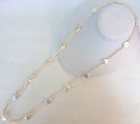 Large coin-shaped pearls on a 36 inch string of small round pearls.